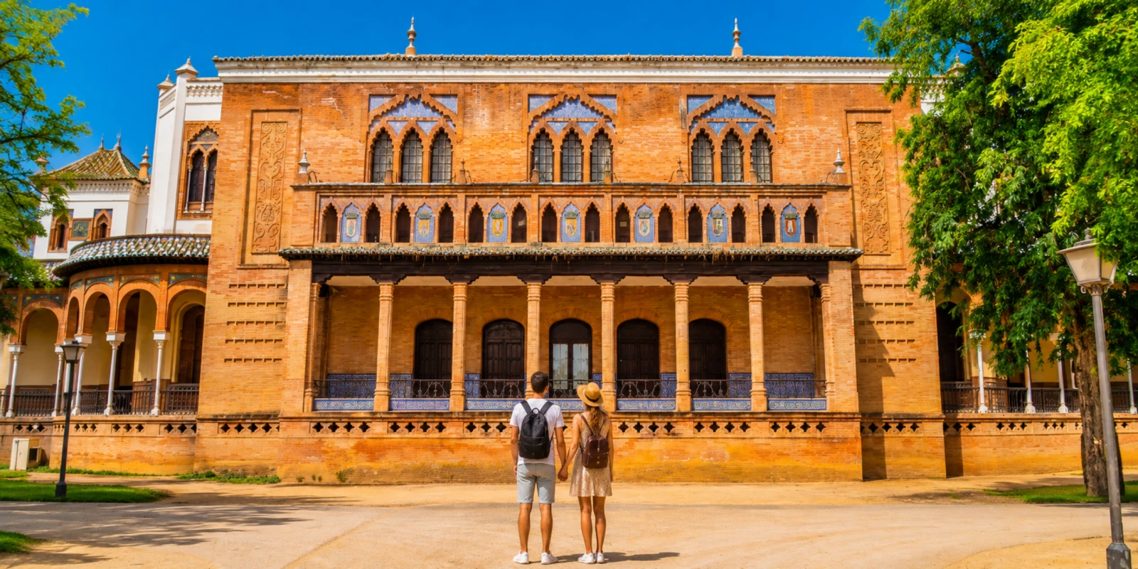 Brick and tile facade of the Pabellón Mudéjar on Plaza de América, home of the museum